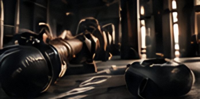 Boxing gloves and dumbbells on a gym floor
